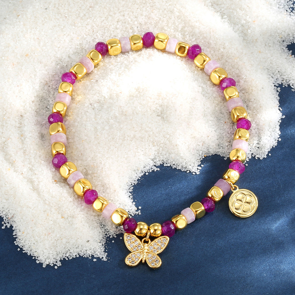 pink bead butterfly bracelet on a blue display