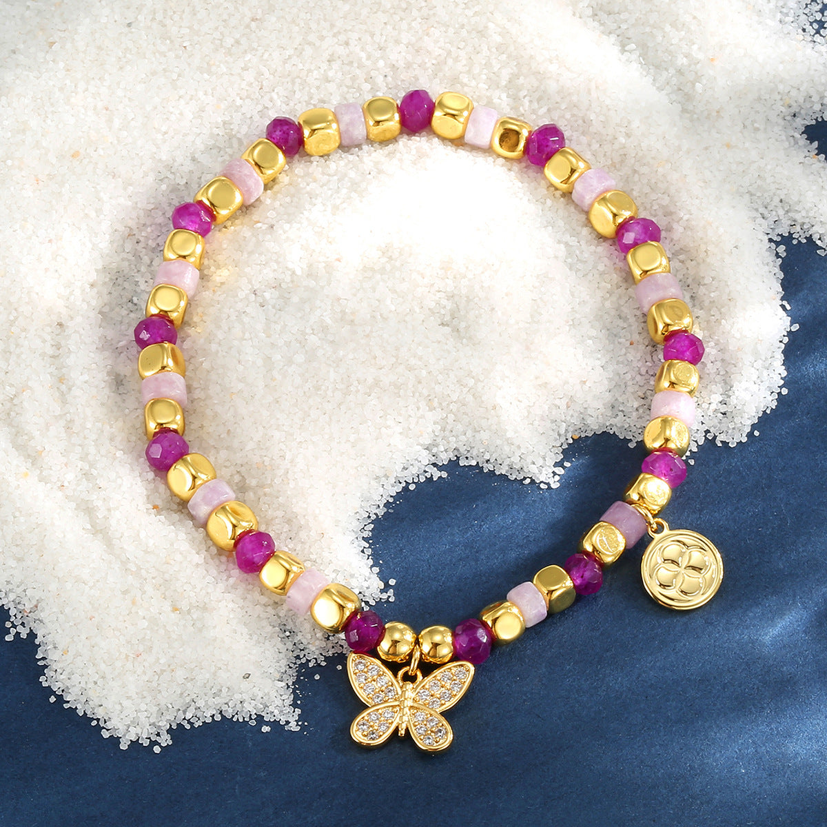 pink bead butterfly bracelet on a blue display