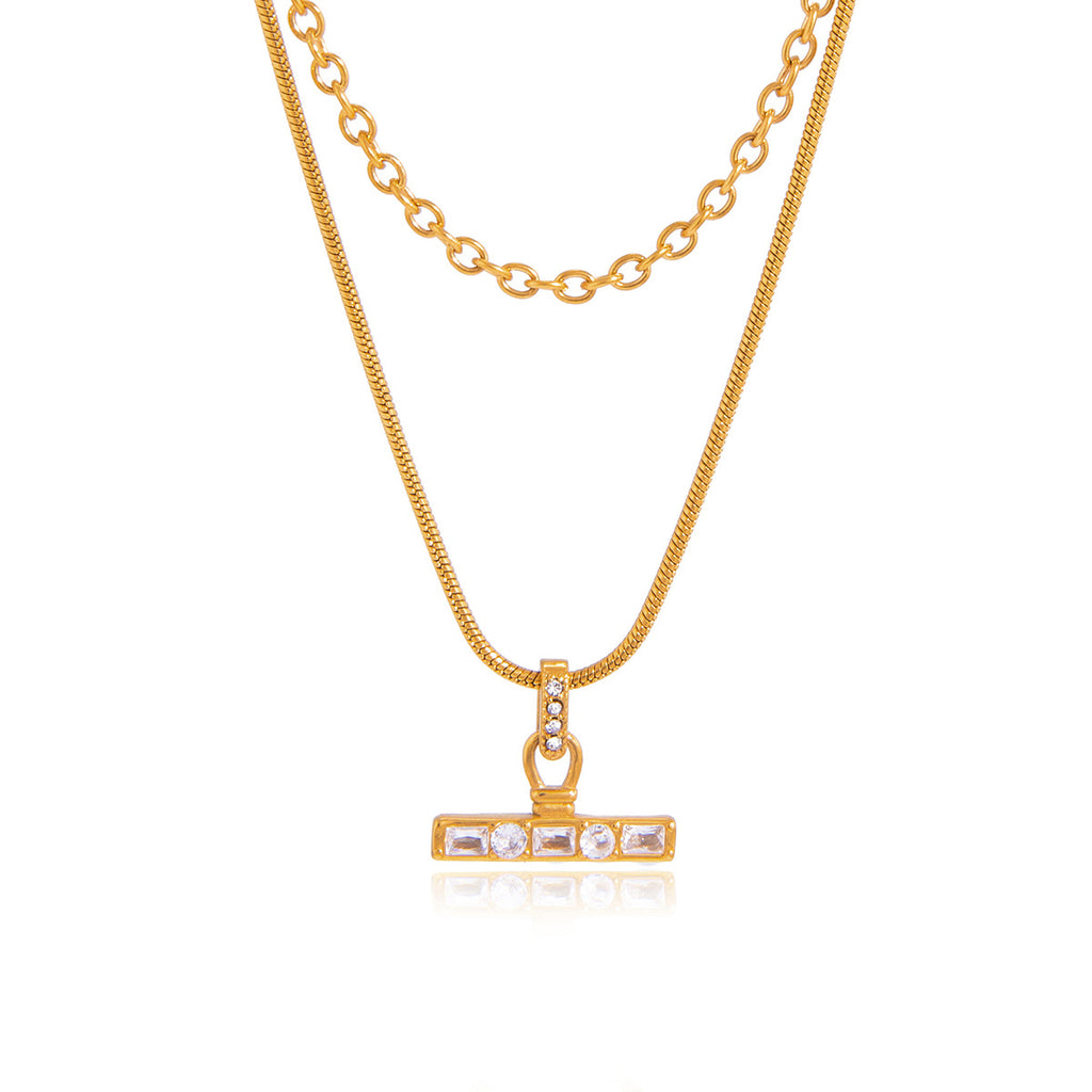Gold-tone layered necklace on white