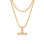 Gold-tone layered necklace on white