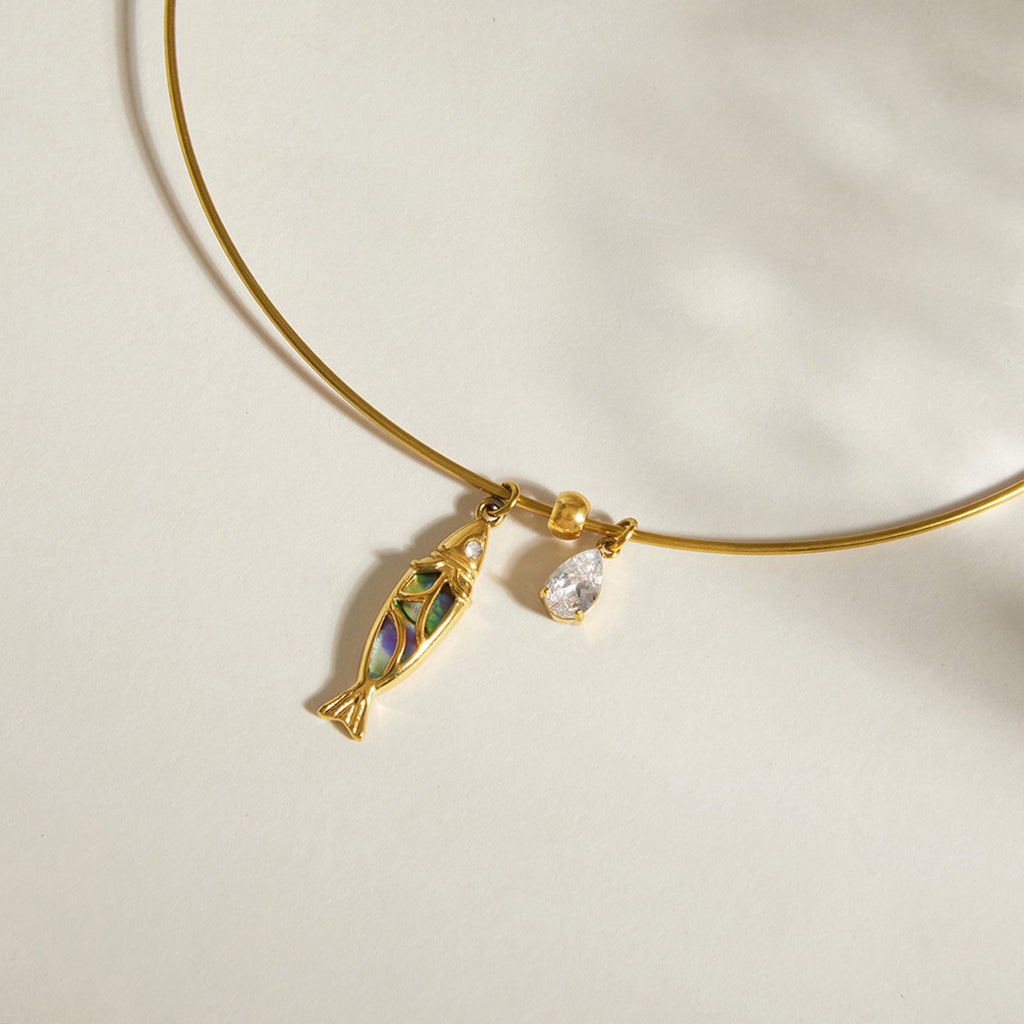 Multicolor fish inlay and pear-shaped clear drop detail