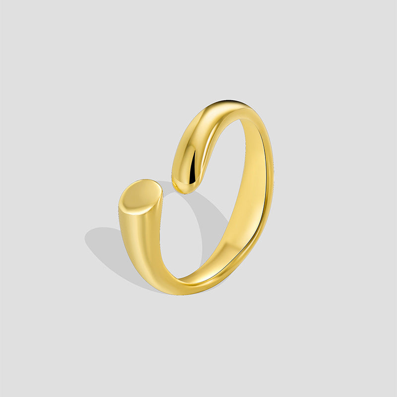 gold plated brass polished bypass open ring on a gray background