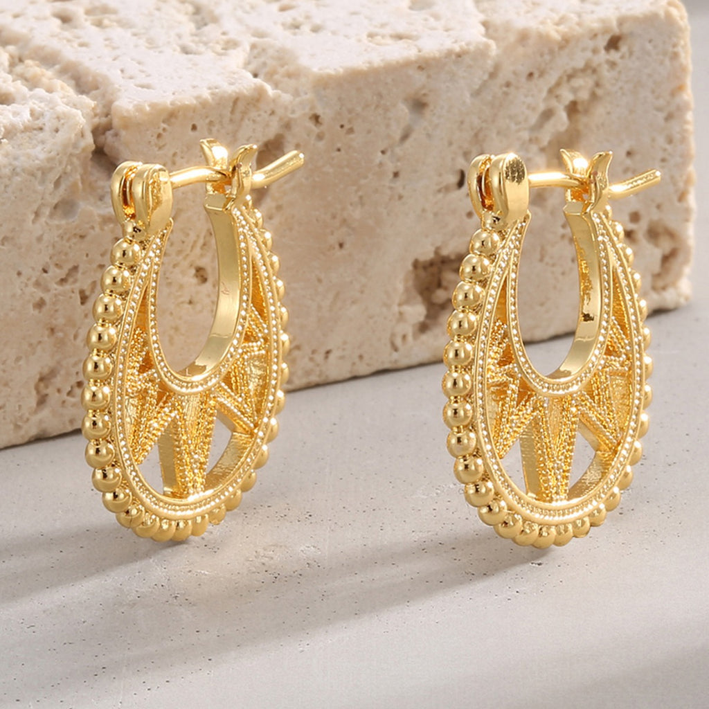 gold plated beaded openwork hoop earrings on stone