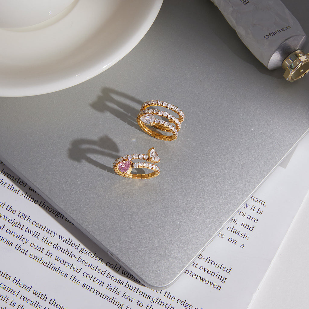Pear-accent rings displayed on a pale surface
