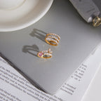 Pear-accent rings displayed on a pale surface