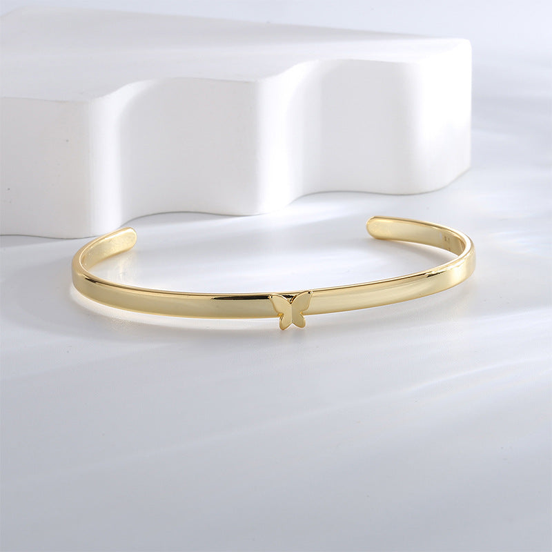 front view of slim gold plated butterfly open cuff