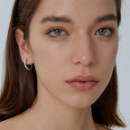 small blue resin accent hoops worn on the ear