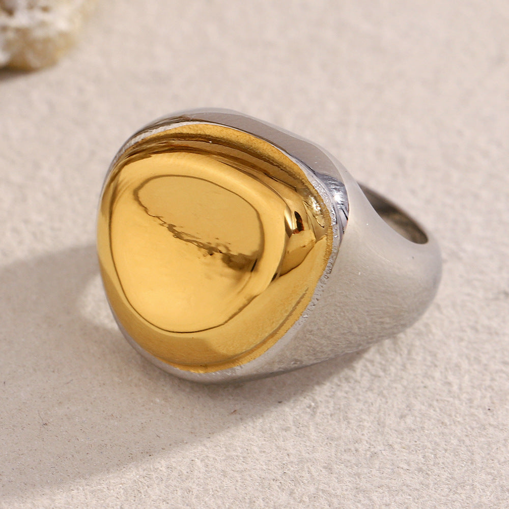 two-tone stainless steel signet ring with a gold plated pebble dome