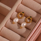 Gold plated pearl drop earrings displayed in a jewelry box