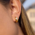 gold plated oval stone teardrop huggie earring worn on ear