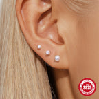 graduated white resin bead flat-back earrings worn on the lobe