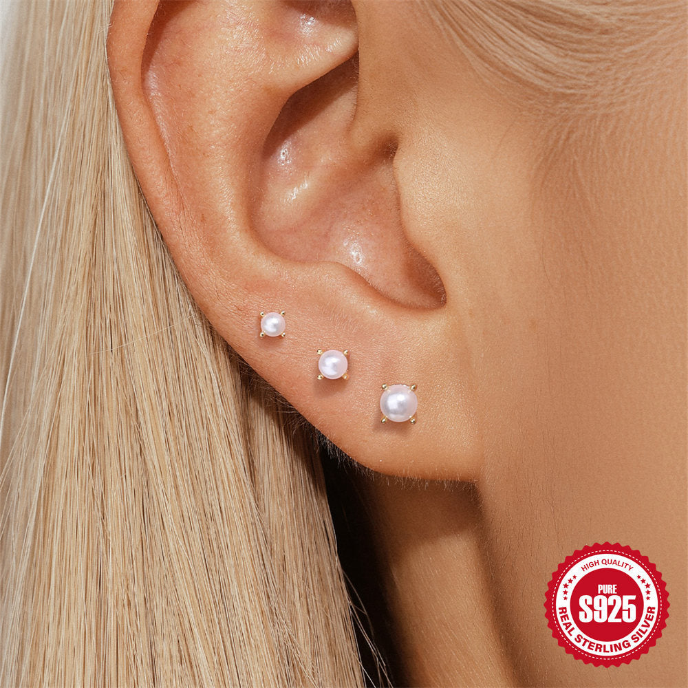 graduated white resin bead flat-back earrings worn on the lobe