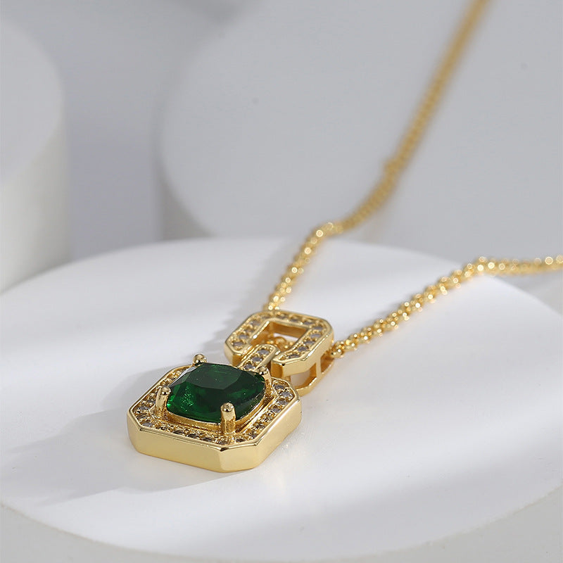 Angled view of the green center stone and gold plated pendant frame