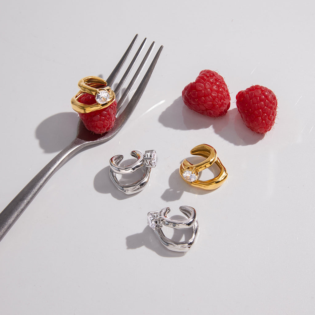 Open-loop ear cuffs arranged on a table