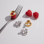 Open-loop ear cuffs arranged on a table