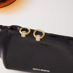 Two-tone stainless steel loop hoop earrings on display