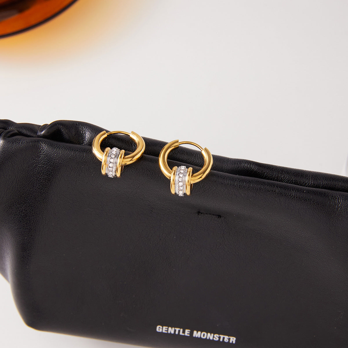 Two-tone stainless steel loop hoop earrings on display