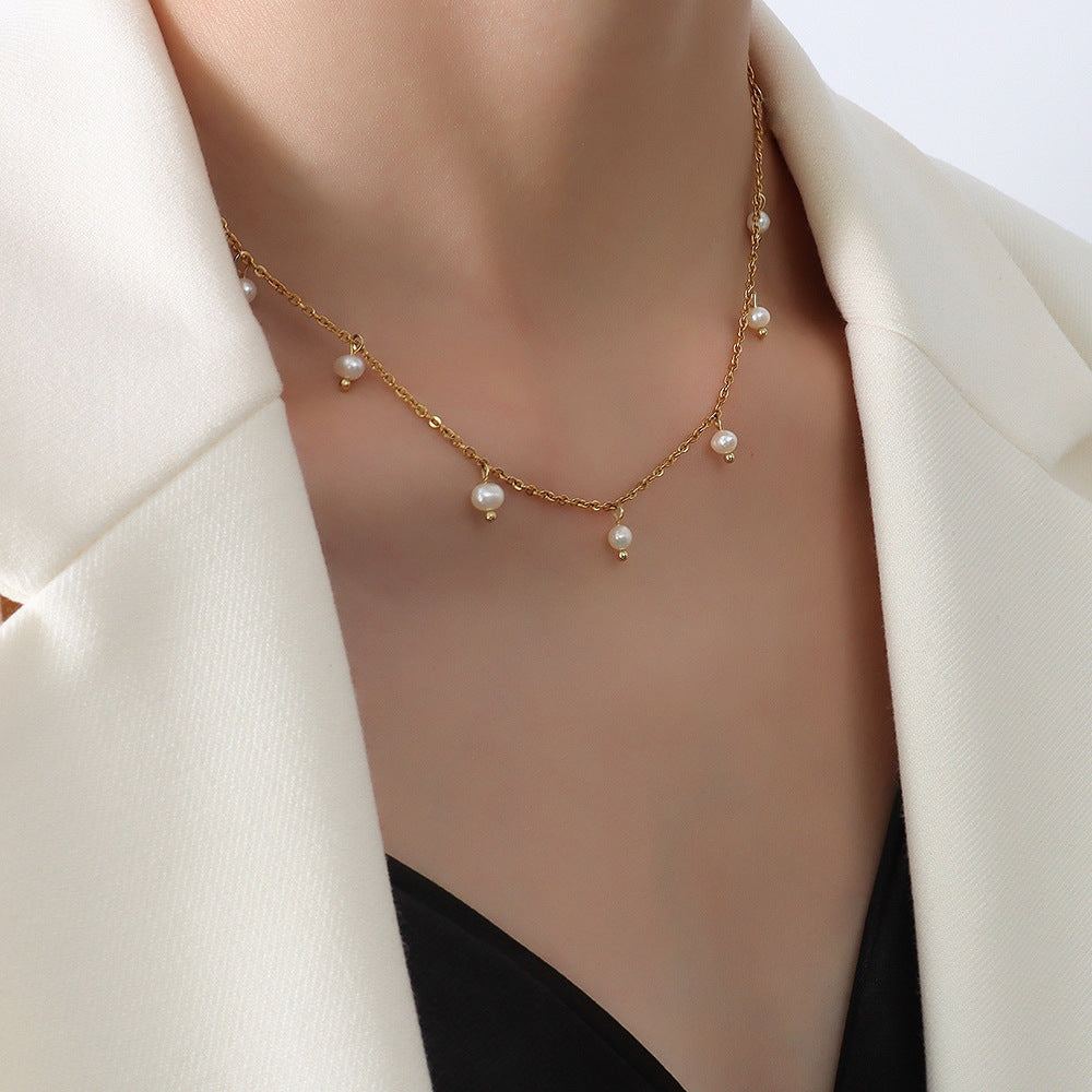 model wearing a delicate gold plated pearl-style station necklace
