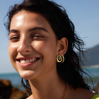 Green oval accent spiral earrings shown on a model