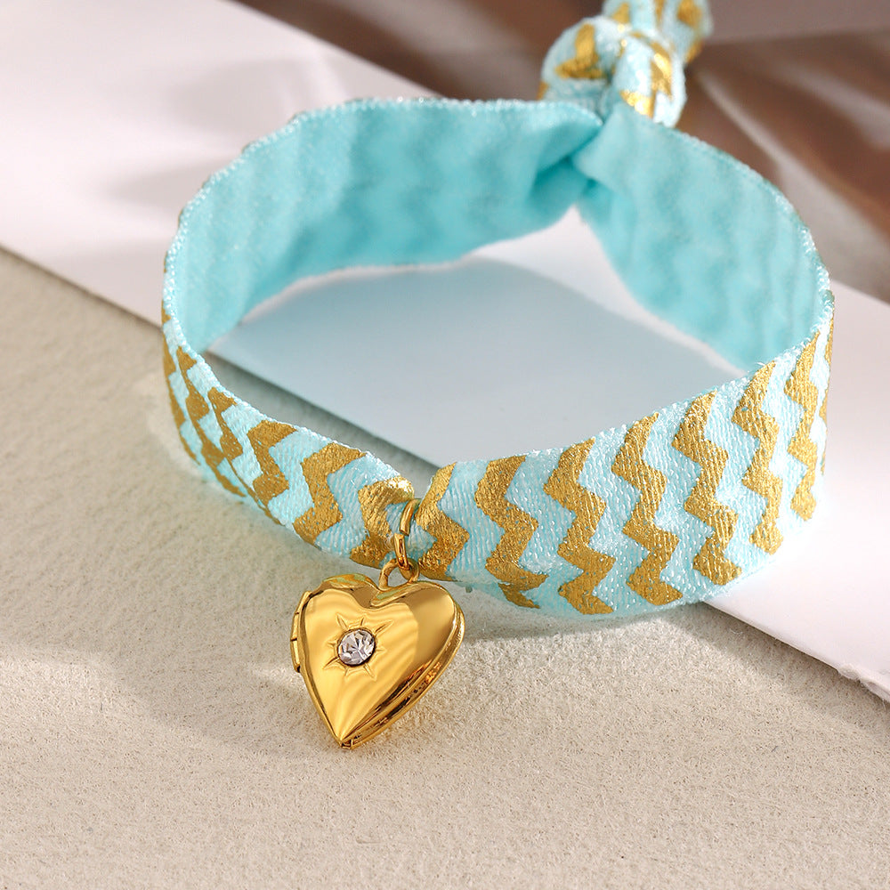 Blue Fabric Tie Bracelet with Gold Plated Stainless Steel Heart Locket — blue fabric tie detail