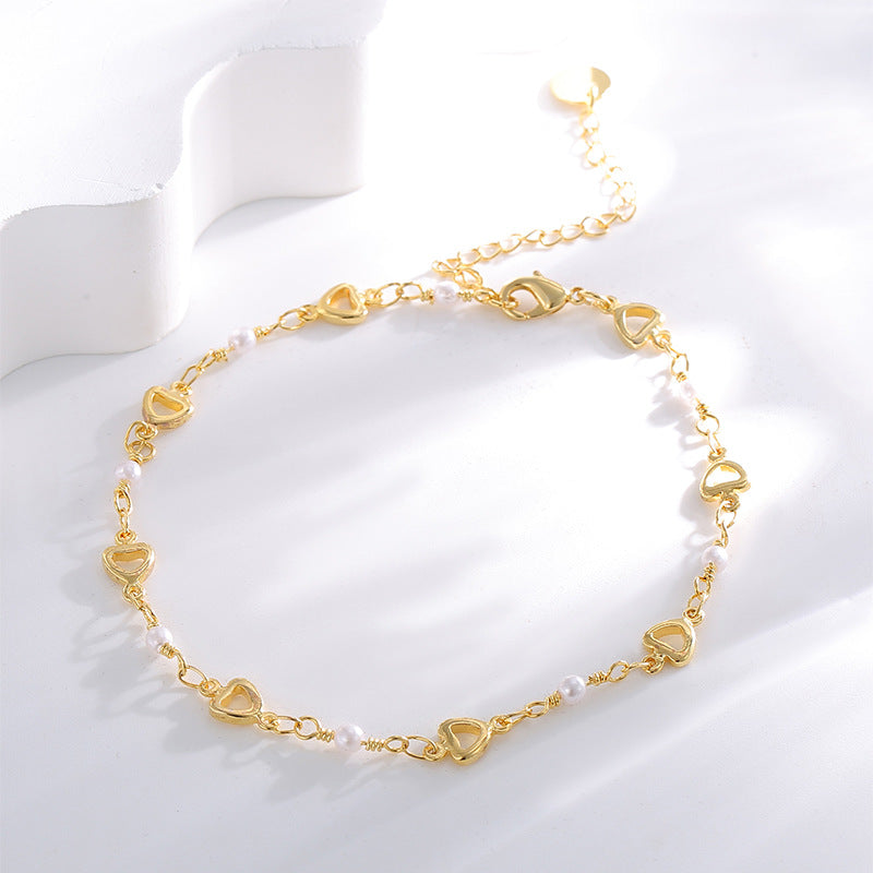 open-heart white bead anklet arranged on a white display
