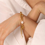 model wearing gold plated oval-link bracelet with white pearl accents