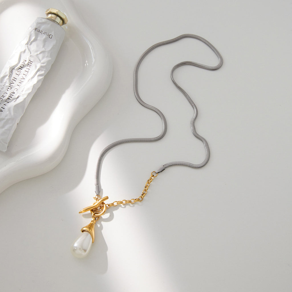 Full mixed-chain toggle necklace arranged on a pale surface