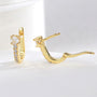gold plated huggie hoops with large round and graduated clear zirconia