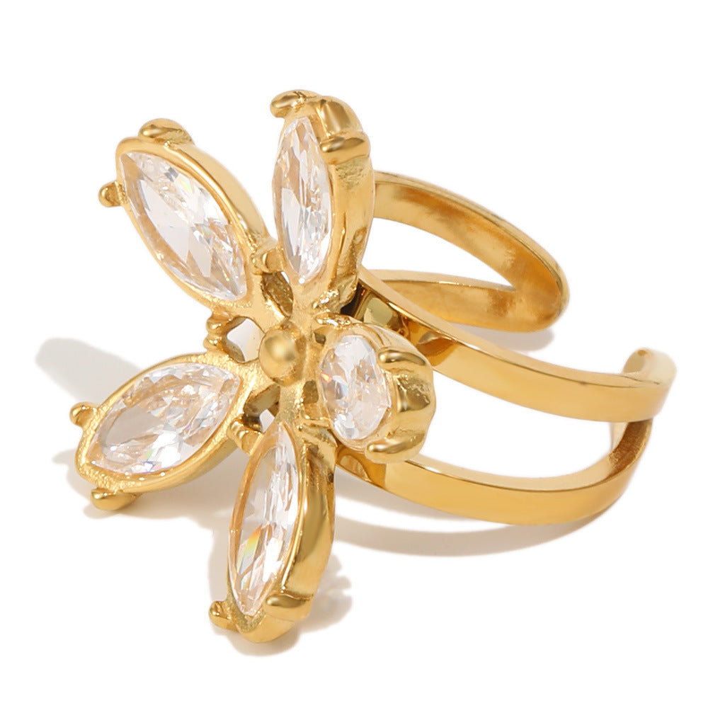 isolated gold plated floral open ring with marquise clear stones