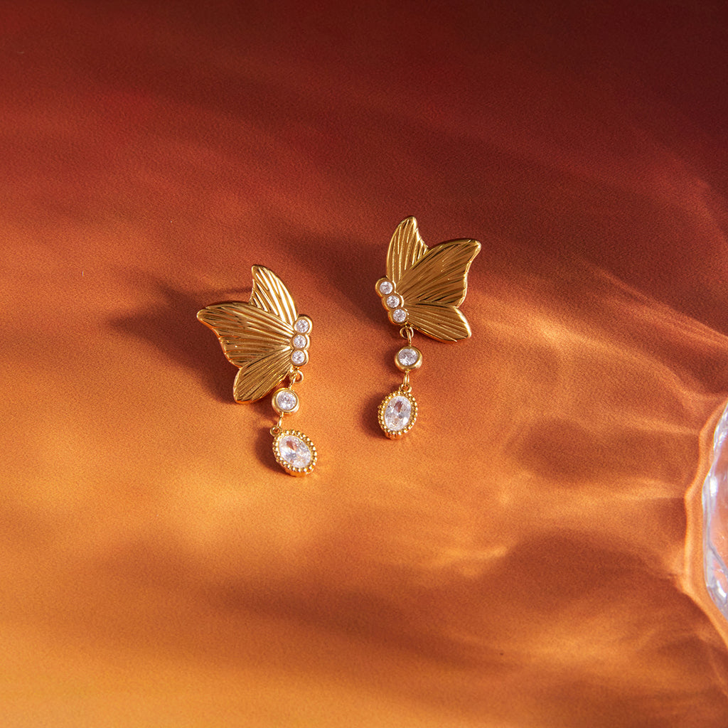 pair of sculpted butterfly earrings with oval clear drops