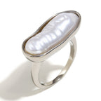 isolated silver-finish stainless steel ring with elongated white pearl