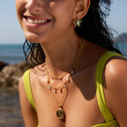 Spiral pendant and star earrings worn with layering chains