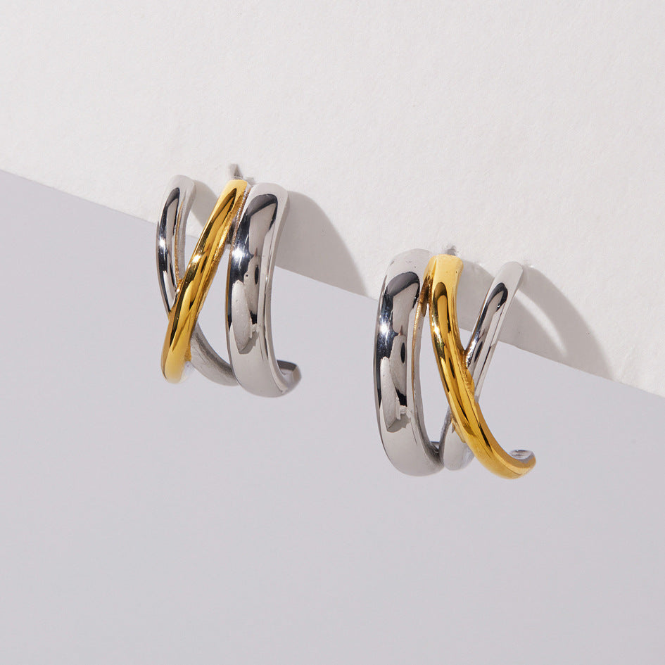 Gold diagonal line crossing silver tone curved bands