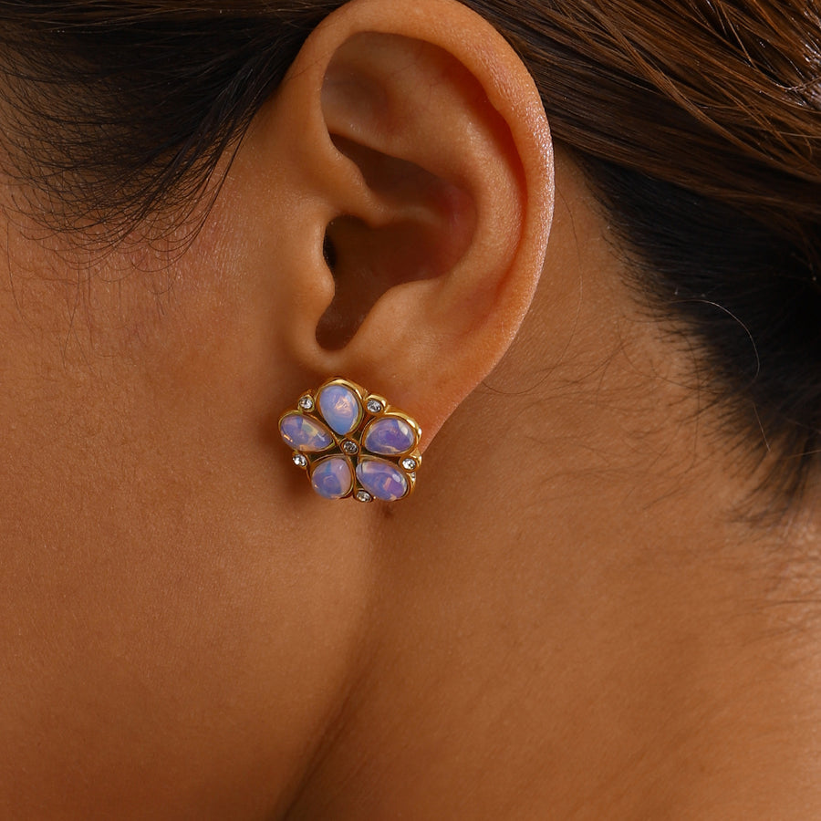 gold plated pearlescent flower stud earrings worn on ear