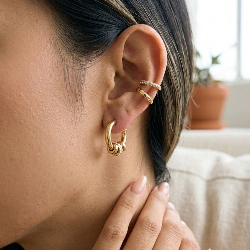 Gold-tone ring-accent hoop worn on an ear