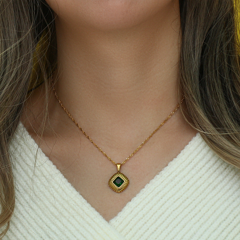 green stone square pendant necklace worn at the collarbone