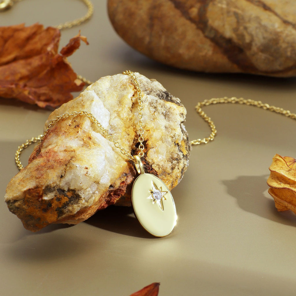 starburst oval pendant necklace displayed on a natural mineral