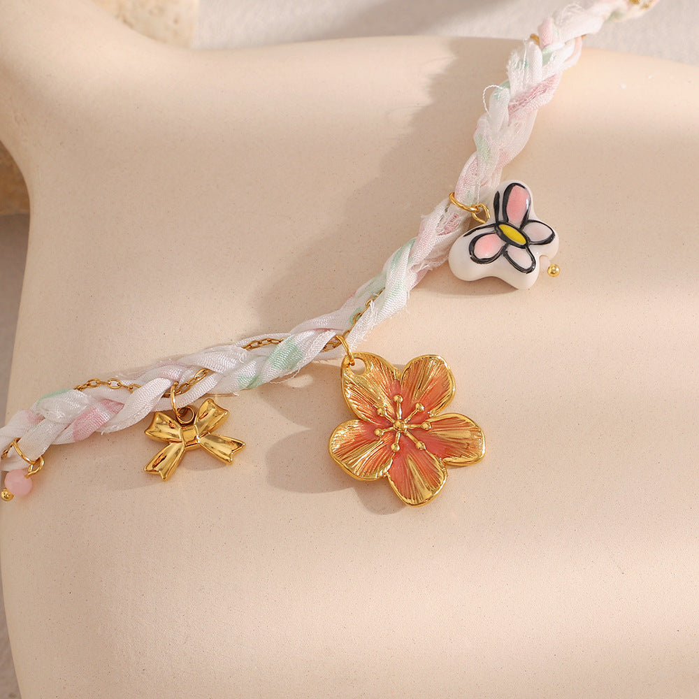 Close-up of warm-colored flower charm and pastel braid