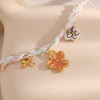 Close-up of warm-colored flower charm and pastel braid