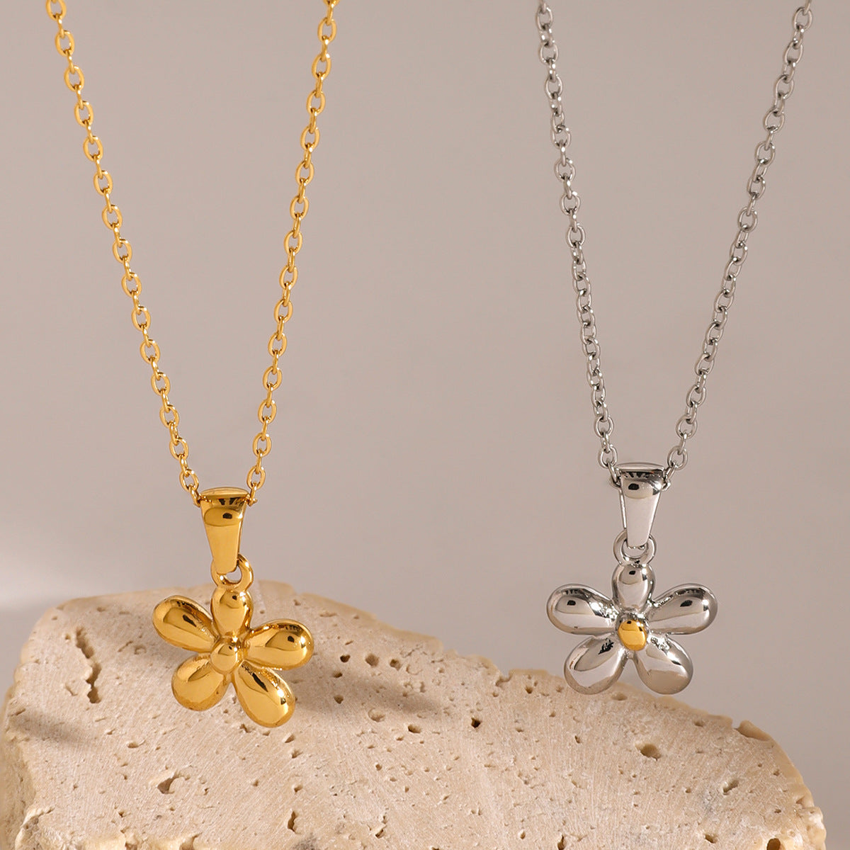 Five-petal stainless steel flower necklaces on display