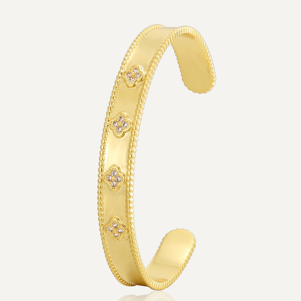 gold plated clover clear stone open bangle on white