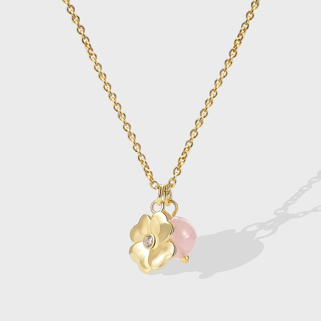 gold plated floral pendant necklace with pink quartz bead and clear center accent