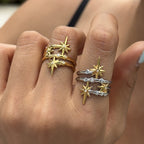 Gold tone and two-tone starburst rings worn on fingers