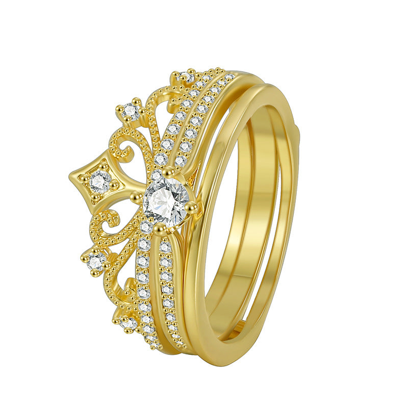 isolated gold plated crown scroll ring with clear accent stones