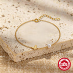 butterfly anklet with pearl-style bead styled on a stone display