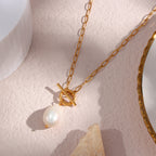 oval-link necklace with front ring-and-bar toggle and white pearl drop