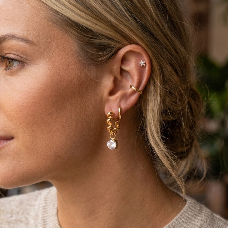 Twisted zirconia drop hoop worn on ear