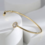 angled close-up of gold plated oval stone cuff bracelet