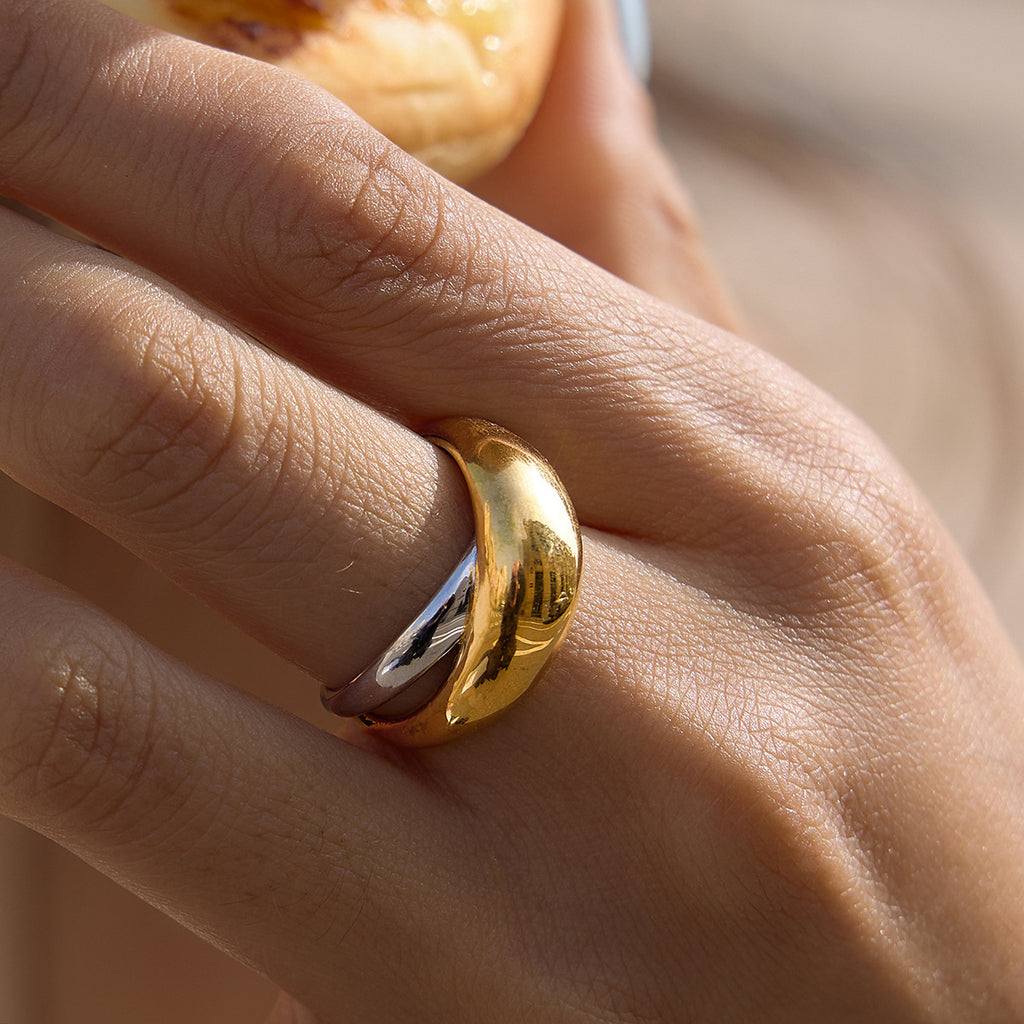 Two-tone domed crossover ring worn close-up