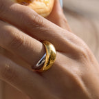 Two-tone domed crossover ring worn close-up